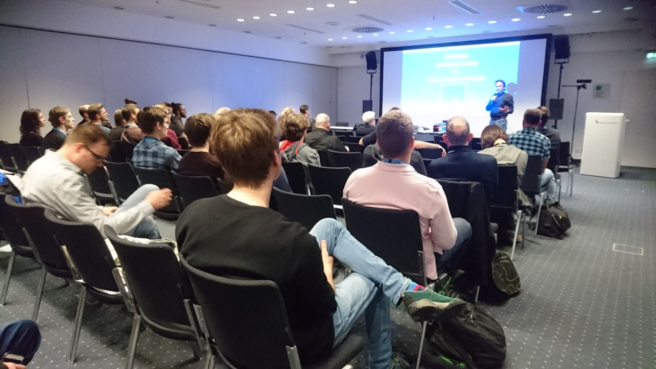 Das Bild zeigt eine Collage aus acht Porträtfotos verschiedener Personen, die vermutlich als Speaker auf der Prolight + Sound 2025 auftreten werden. Die Bilder sind in einem blauen Rahmen angeordnet und vermitteln eine vielfältige, kreative und technikaffine Atmosphäre.

Oben links ist ein Mann mit dunklerem Haar und einem schwarzen Hemd zu sehen, der freundlich in die Kamera blickt. In der Mitte oben erscheint ein glatzköpfiger Mann mit Bart, Brille und einem hellblauen Hemd, der einladend lächelt. Oben rechts befindet sich eine Frau mit kurzen braunen Haaren und Brille, die vor einem farbenfrohen Hintergrund steht.

In der linken Bildmitte hält eine Frau mit langen Haaren eine E-Gitarre nach vorne und blickt entschlossen in die Kamera, was auf eine musikalische Performance hinweisen könnte. Rechts daneben sieht man eine Frau mit roten Haaren inmitten einer beeindruckenden Veranstaltungstechnik-Kulisse, umgeben von bunten Lichtern und Displays.

Unten links ist ein Mann mit gewelltem Haar und dunklem Hemd zu sehen, während im Hintergrund violettes Bühnenlicht für eine atmosphärische Wirkung sorgt. In der unteren Bildmitte trägt eine Frau ein futuristisches, weißes Outfit mit technologisch anmutenden Details, darunter mehrere kleine Sensoren oder Kameras auf ihrer Kleidung. Unten rechts hält ein Mann mit Schnurrbart und kariertem Sakko ein Mikrofon in der Hand und gestikuliert engagiert, was auf eine Moderation oder Keynote hindeutet.

Insgesamt präsentiert die Collage eine spannende Mischung aus kreativen Köpfen, Technikexperten und Künstlern, die das Programm der Prolight + Sound 2025 mit innovativen Vorträgen und Performances bereichern könnten.