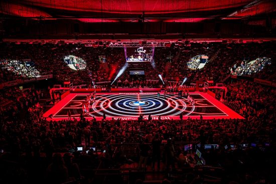 A red-lit LED glass floor stages a basketball game at BMW Park Munich.