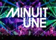 Das Bild zeigt eine beeindruckende Live-Bühnenszene mit einer dynamischen Lichtshow. Der Hintergrund ist von intensiven grünen und violetten Lichteffekten geprägt, die strahlenförmig von verschiedenen Punkten ausgehen und den gesamten Raum einhüllen. In der Mitte des Bildes befindet sich das große, weiße Logo von Minuit Une, das prominent über die Szene gelegt wurde. Auf der Bühne stehen mehrere Musiker, die von einer aufwendigen Lichtinstallation umgeben sind. Die Beleuchtung erzeugt eine immersive Atmosphäre, die typisch für die IVL-Technologie von Minuit Une ist. Die Kombination aus multidirektionalen Lichtstrahlen, Projektionen und der energiegeladenen Live-Performance vermittelt den Eindruck eines intensiven, mitreißenden Konzerterlebnisses.