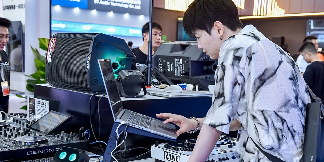 Visitors test DJ and audio equipment at Prolight + Sound Guangzhou
