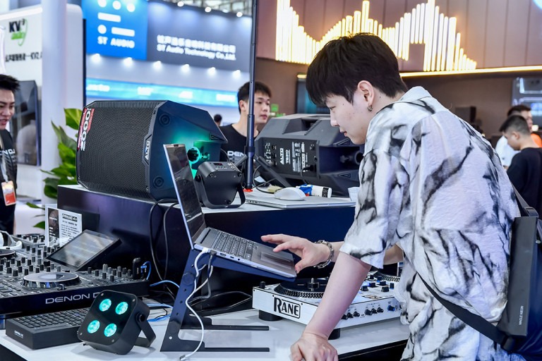 Visitors test DJ and audio equipment at Prolight + Sound Guangzhou