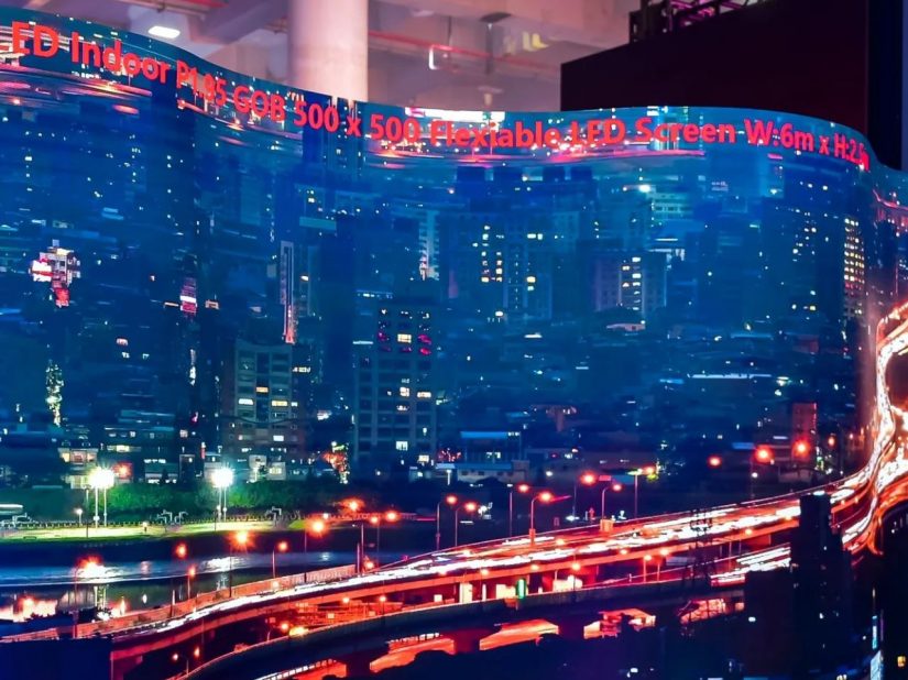 Curved LED wall shows nocturnal city view on a trade fair stand