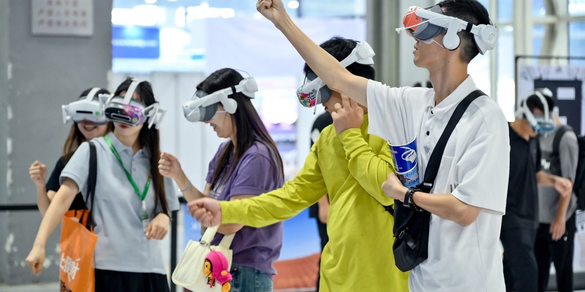 Visitors try out VR headsets at Prolight + Sound Guangzhou