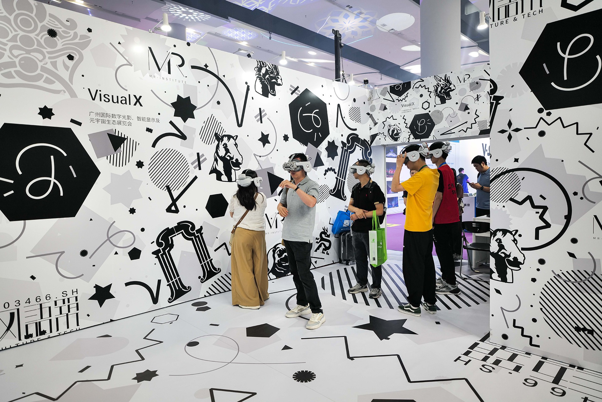 Several people test VR headsets in a graphically designed immersive showroom.