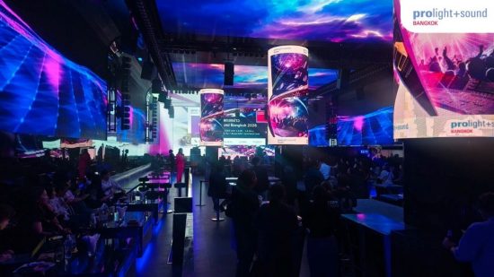 Stage area with large LED screens and guests
