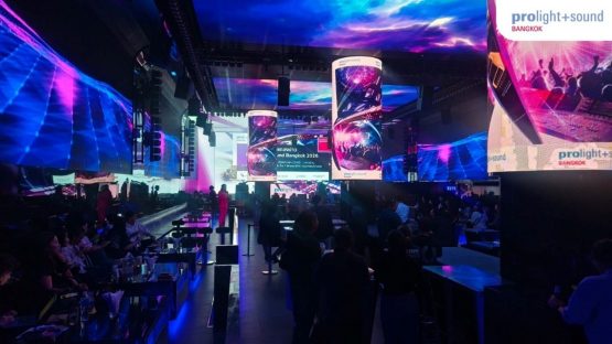 Stage area with large LED screens and guests