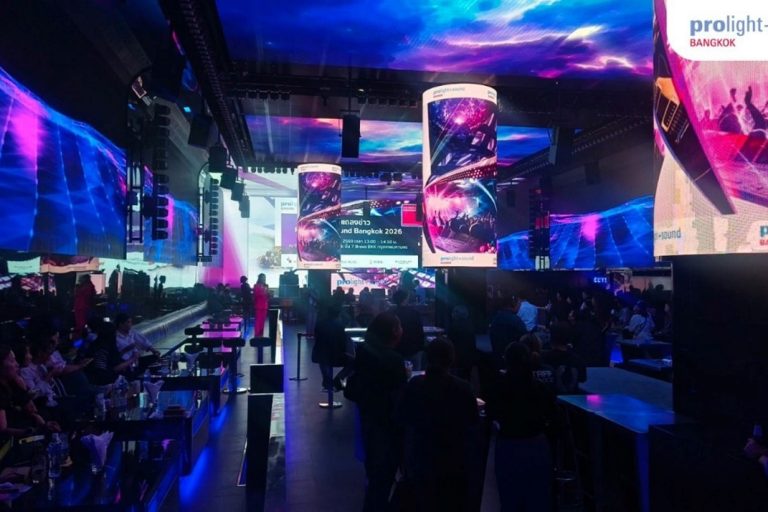 Stage area with large LED screens and guests