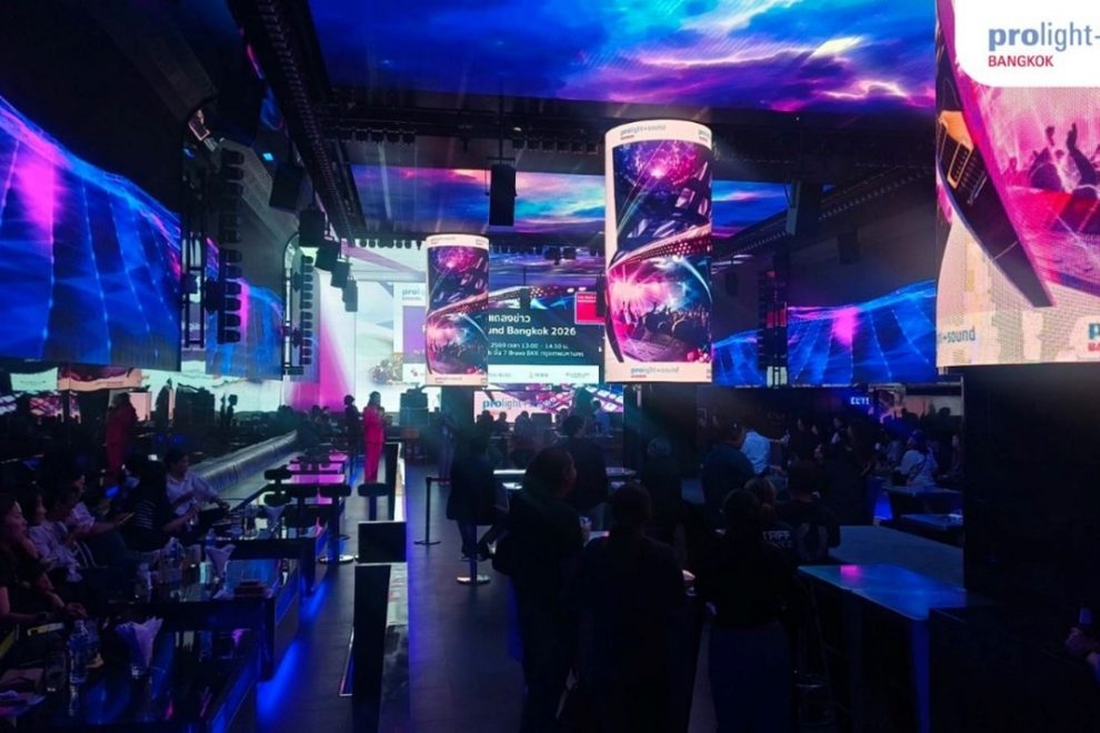 Stage area with large LED screens and guests