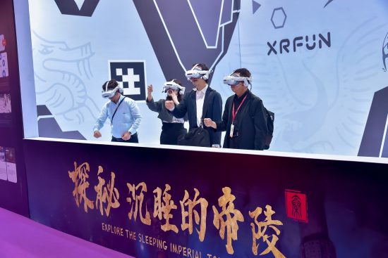Four visitors test VR headsets at the XRFun stand.