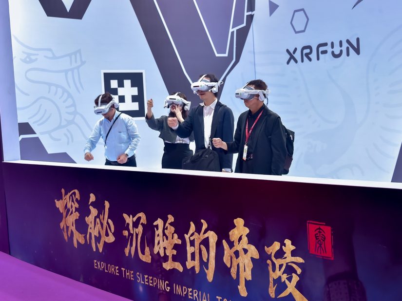 Four visitors test VR headsets at the XRFun stand.